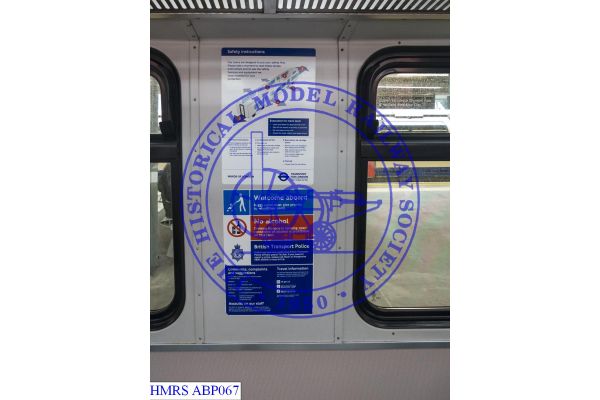 [ABP067] 715858 EMU pantograph carriage 71446 operated by TfL Rail.  Signage re evacuation, contact police, c
