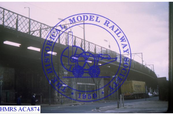 [ACA874] Stepney East, platform on viaduct seen from Commercial Rd below Platform fencing well highlighted, a