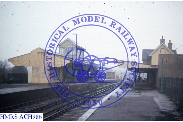 [ACH986] Sandown, General view Nth from Sth end of Down platform, various buildings. Signal box sprouts from