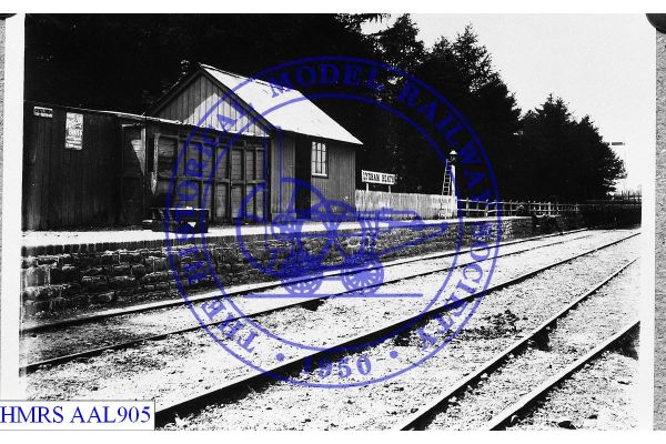 [AAL905] Lydham Heath station, platform face, sign, lamp, fencing c1905