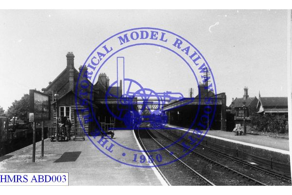 [ABD003] Thetford, W along Up platform, namboard left, buildings, footbridge distant